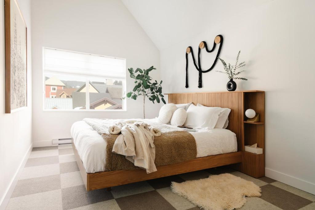 a bedroom with a bed and a window at Ski-in/Ski-out Intentionally Designed Ski Lodge in Whistler