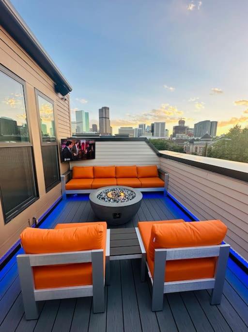 a balcony with orange chairs and a fire pit at Downtown Denver Smart House in Denver