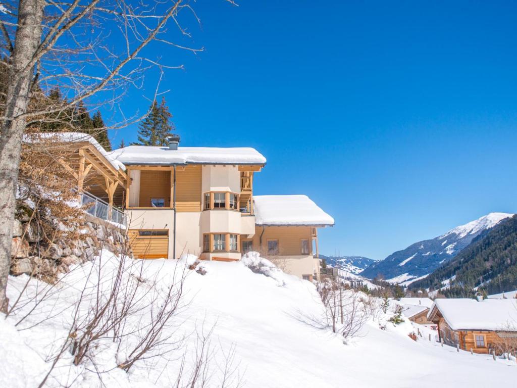 a house on a snow covered hill in the mountains at Hinterlengau in Saalbach-Hinterglemm