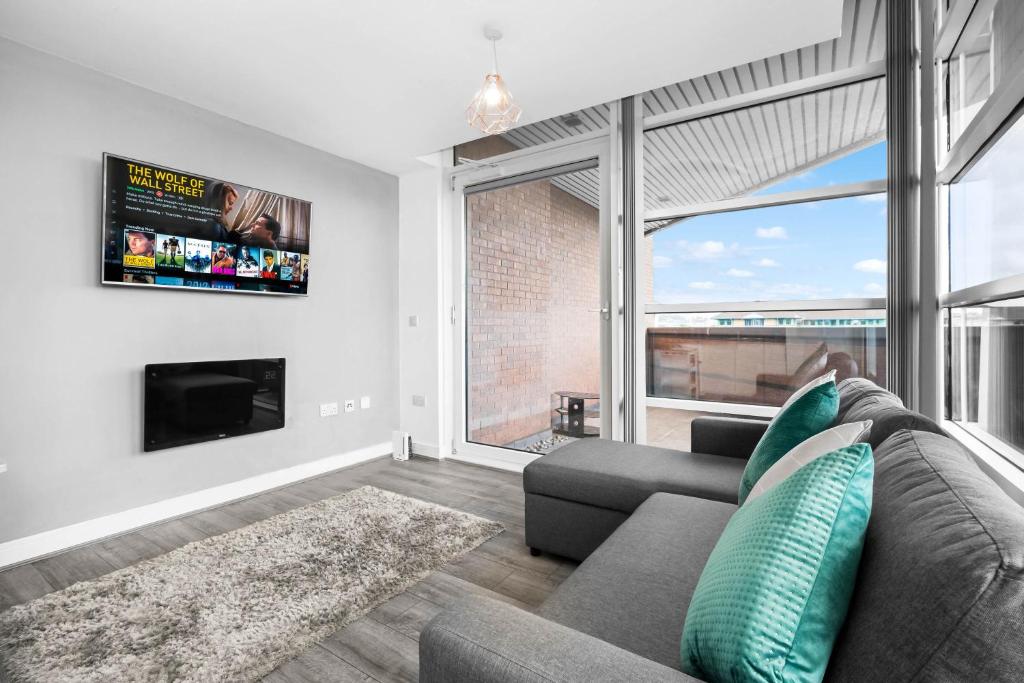 a living room with a couch and a tv at Luxury stay with scenic views in Brierley Hill
