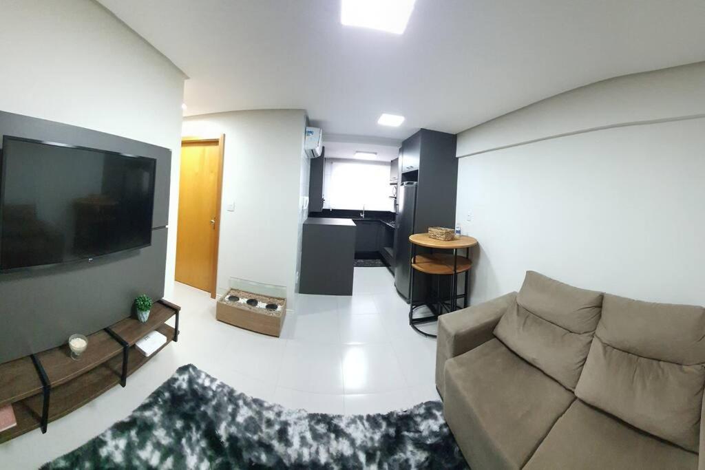 een woonkamer met een bank en een flatscreen-tv bij Delicadeza e aconchego na Serra Gaúcha. in Bento Gonçalves