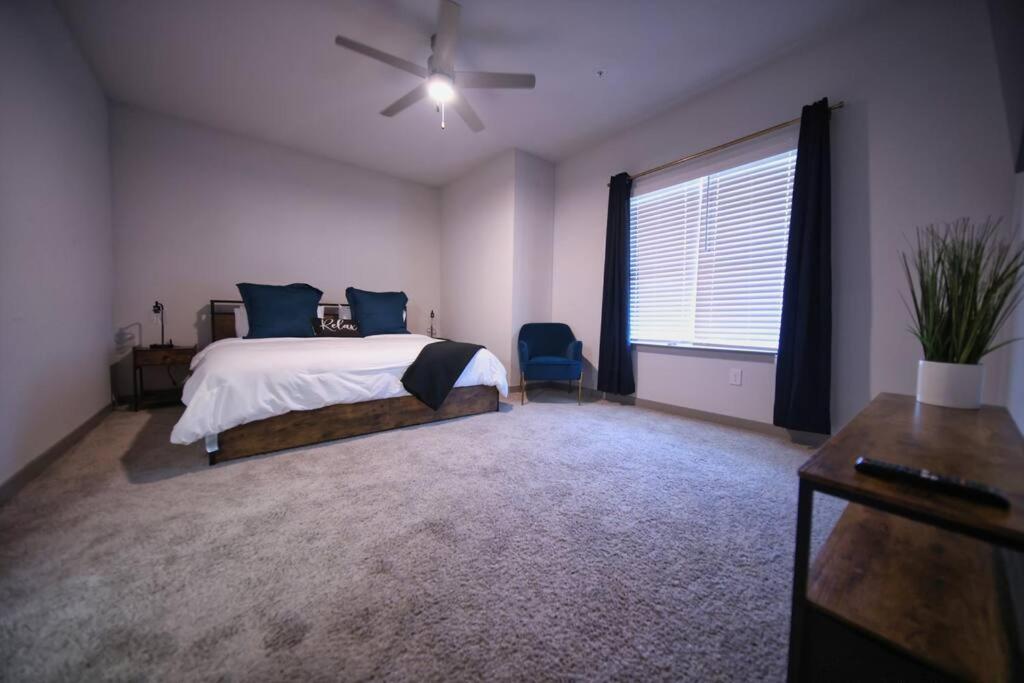 a bedroom with a bed and a ceiling fan at Optimum - Rock Out and Relax! in Birmingham