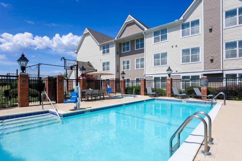 a swimming pool in front of a building at Residence Inn by Marriott Monroe in Monroe