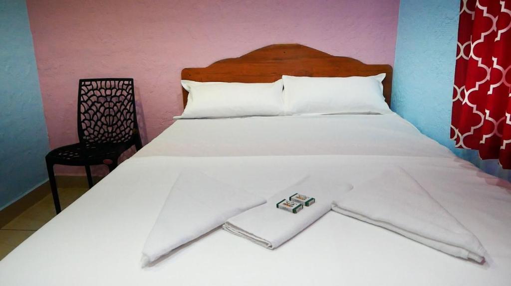 Ένα ή περισσότερα κρεβάτια σε δωμάτιο στο Kichus homestay