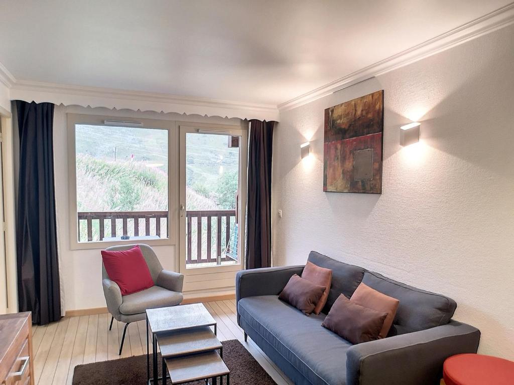 a living room with a couch and a chair at Cocon de 40m² pour 5 personnes avec 2 chambres à Les Menuires, accès direct aux pistes et balcon sud - FR-1-178-379 in Les Bruyères