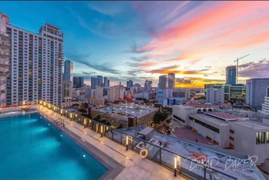 マイアミにあるOcean View Downtown Apt on 23rd Floor with Balcony, Rooftop Pool, Kitchen, Gym, & Restaurantsのスイミングプール付きの市街のスカイラインを望めます。