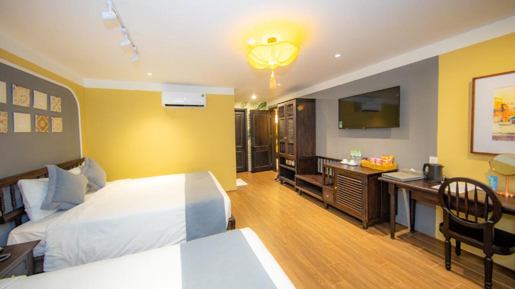 Postel nebo postele na pokoji v ubytování Hoianan Boutique Hotel