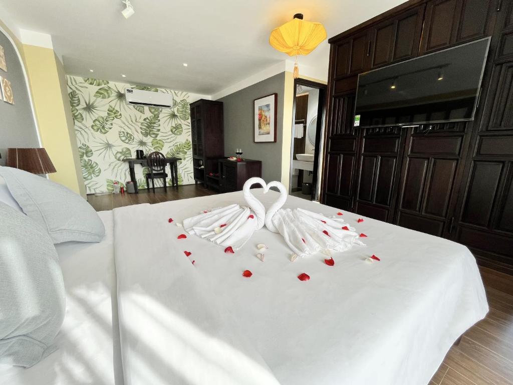 Postel nebo postele na pokoji v ubytování Hoianan Boutique Hotel