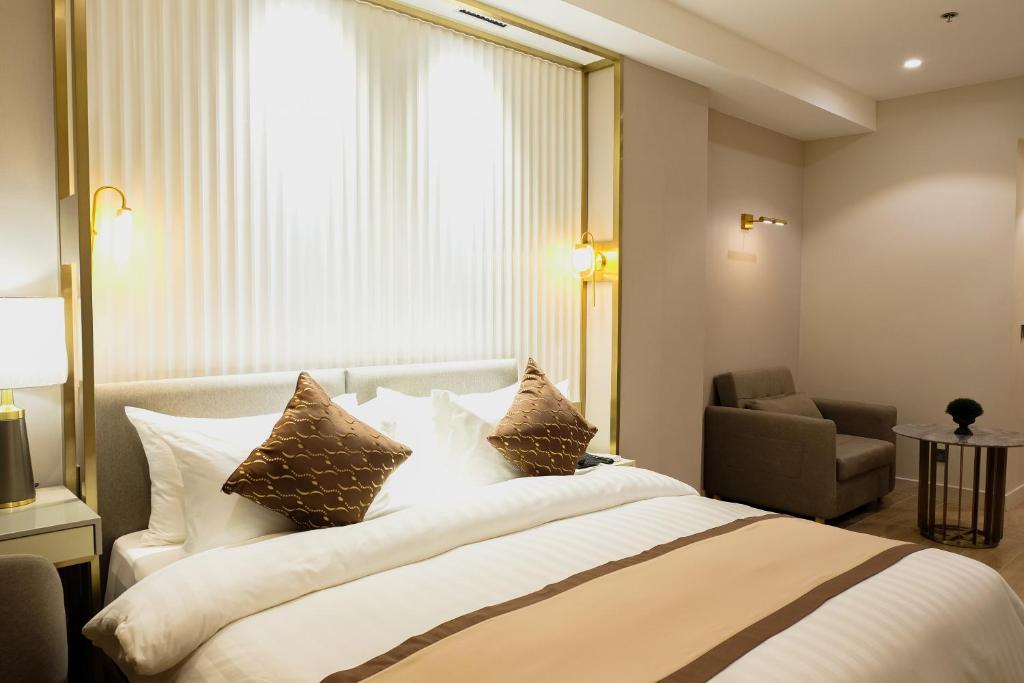 Postel nebo postele na pokoji v ubytování Uma Hotel and Residences