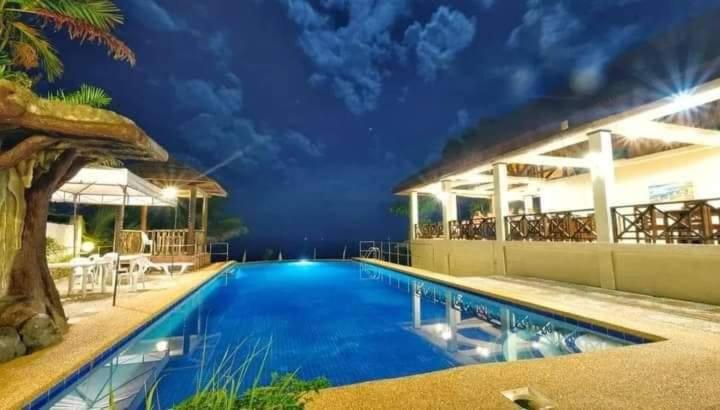 a large swimming pool in a resort at night at LaVeranda Beach Resort in Dauis