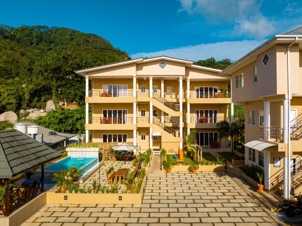 an aerial view of a building with a swimming pool at Tropical Hideaway in Beau Vallon