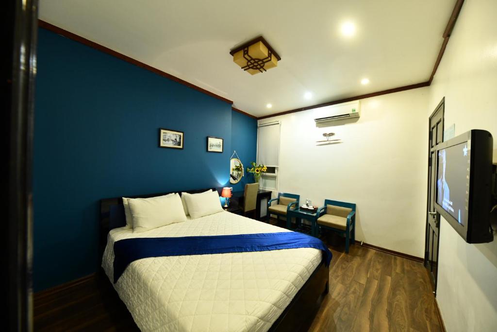 Postel nebo postele na pokoji v ubytování Hanoi Starlight Boutique Hotel