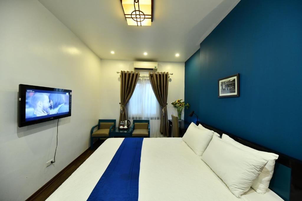 Postel nebo postele na pokoji v ubytování Hanoi Starlight Boutique Hotel