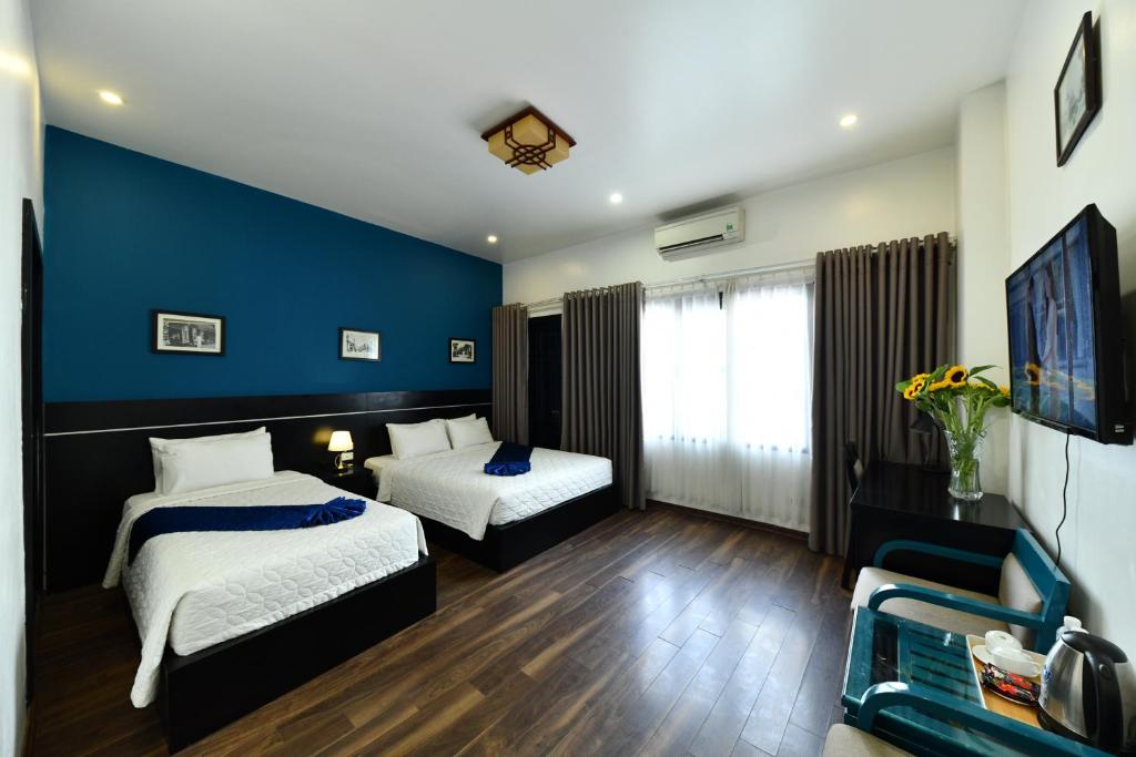 Postel nebo postele na pokoji v ubytování Hanoi Starlight Boutique Hotel