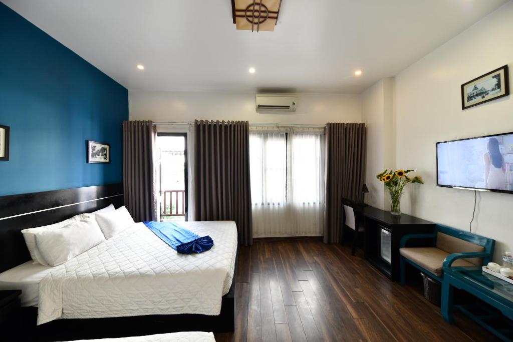 Postel nebo postele na pokoji v ubytování Hanoi Starlight Boutique Hotel