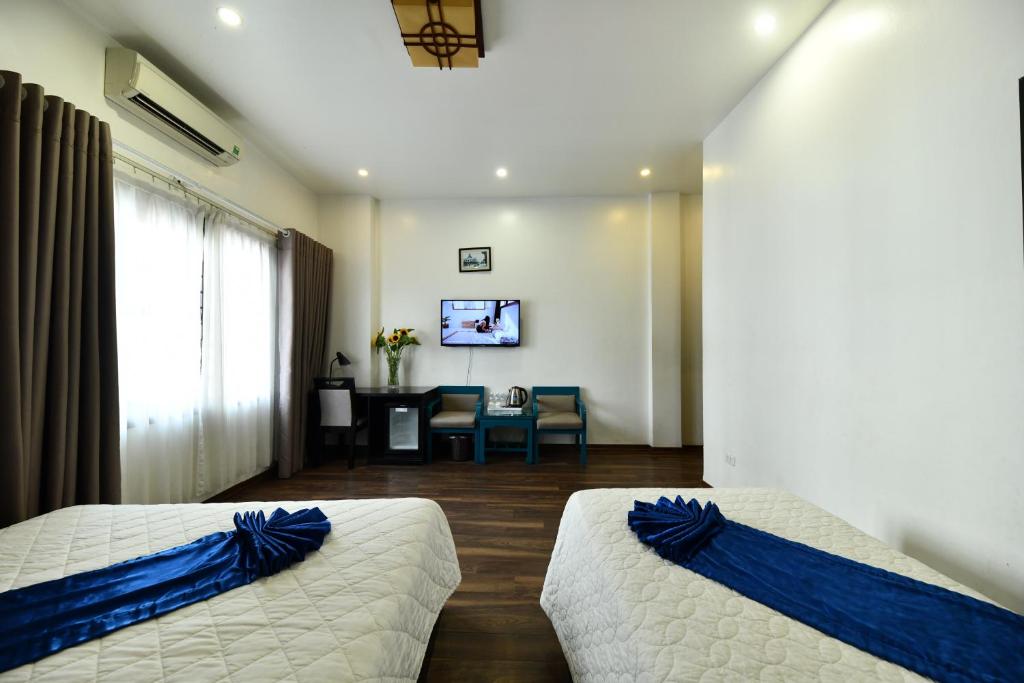 Postel nebo postele na pokoji v ubytování Hanoi Starlight Boutique Hotel