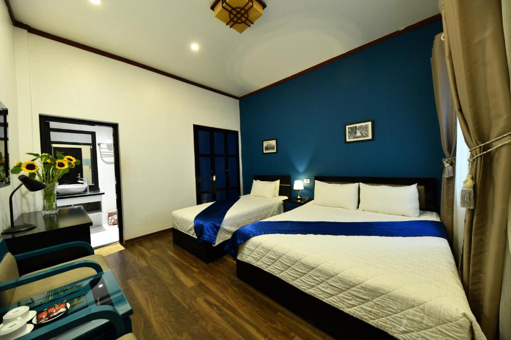 Postel nebo postele na pokoji v ubytování Hanoi Starlight Boutique Hotel