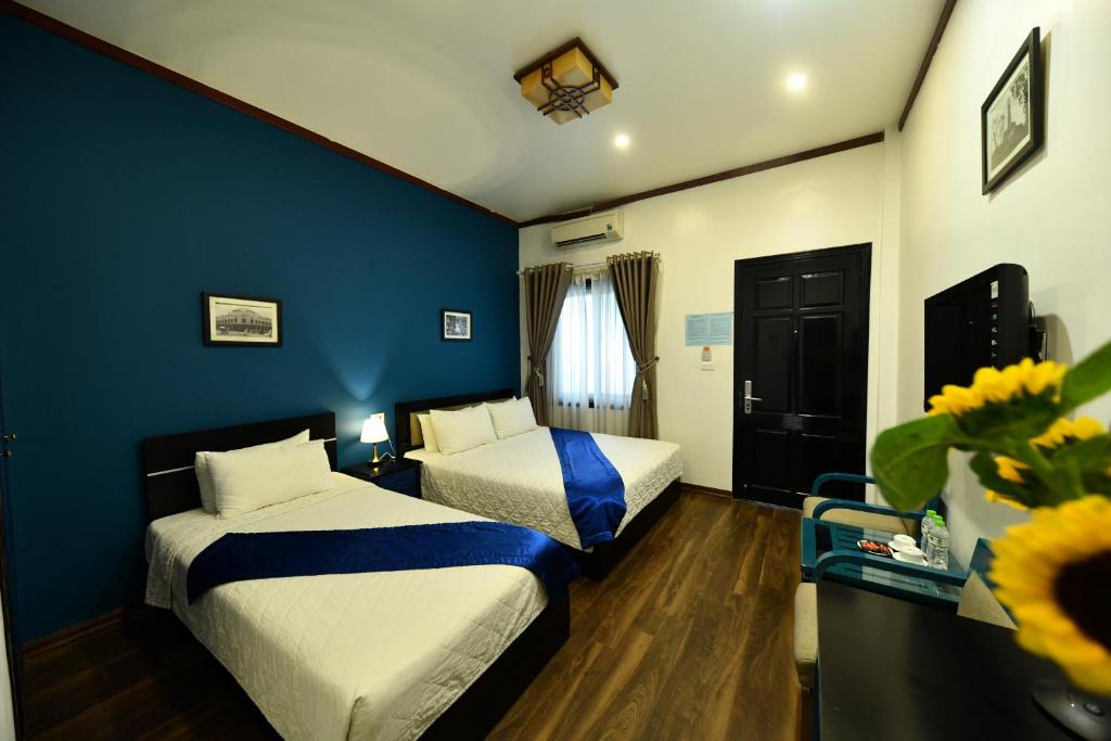 Postel nebo postele na pokoji v ubytování Hanoi Starlight Boutique Hotel