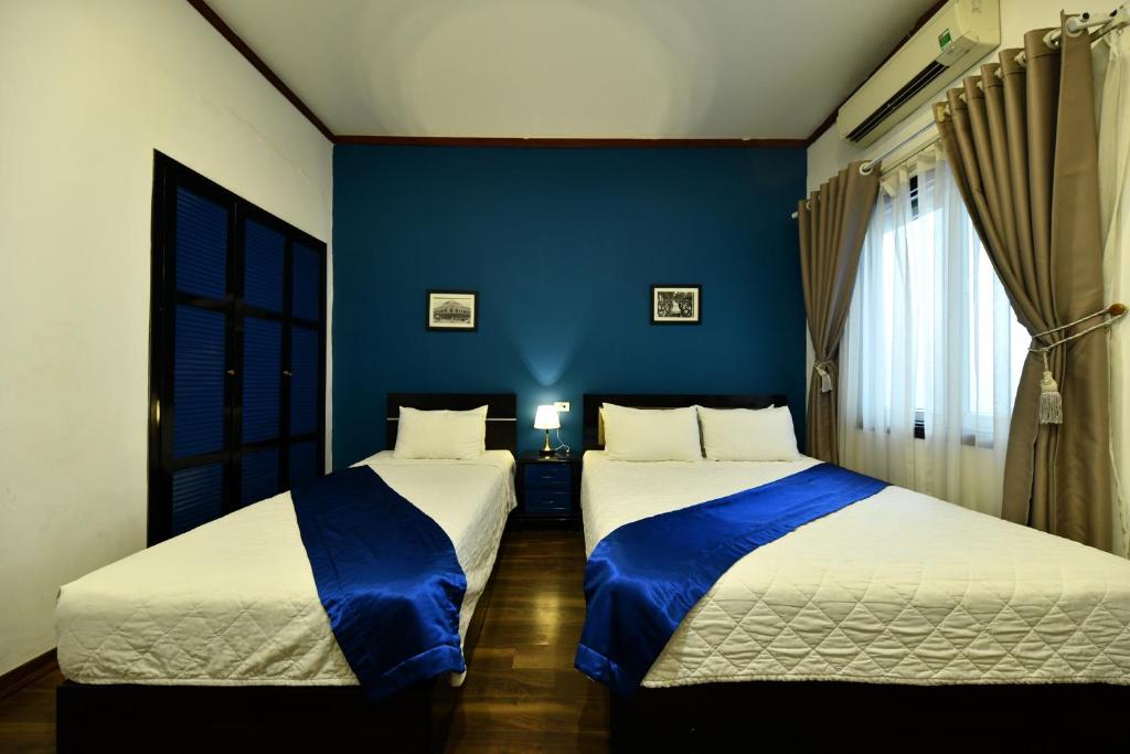 Postel nebo postele na pokoji v ubytování Hanoi Starlight Boutique Hotel