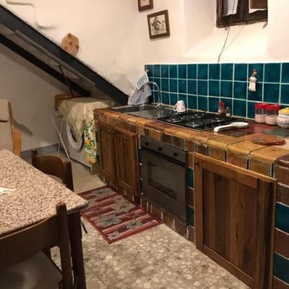 a kitchen with a stove and a counter top at Casa della Luna in Tarano