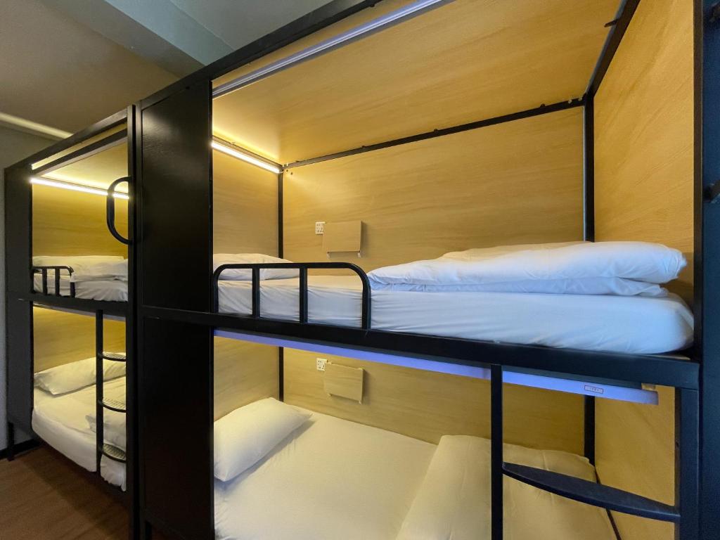 a group of bunk beds in a room at 22 Hours Hostel in Kampong Gadong