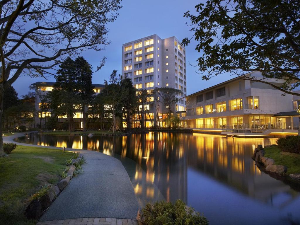 a building next to a river at night at Mars Garden Wood Gotenba in Gotemba