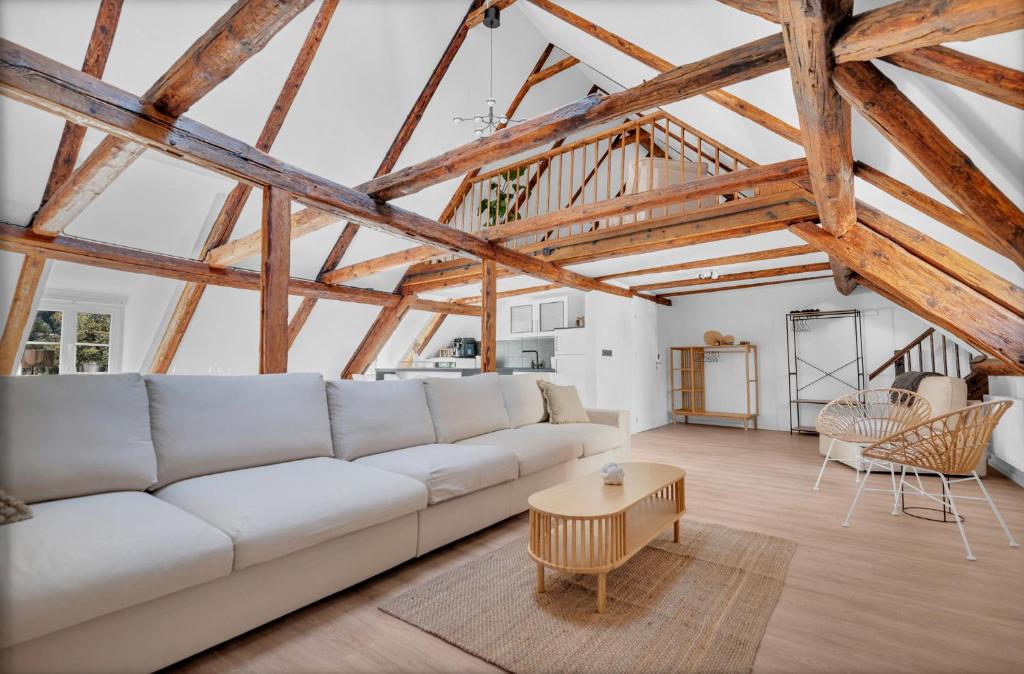 a living room with a white couch and a table at Einzigartig - Schlossblick - Maisonette - Smart TV in Wernigerode