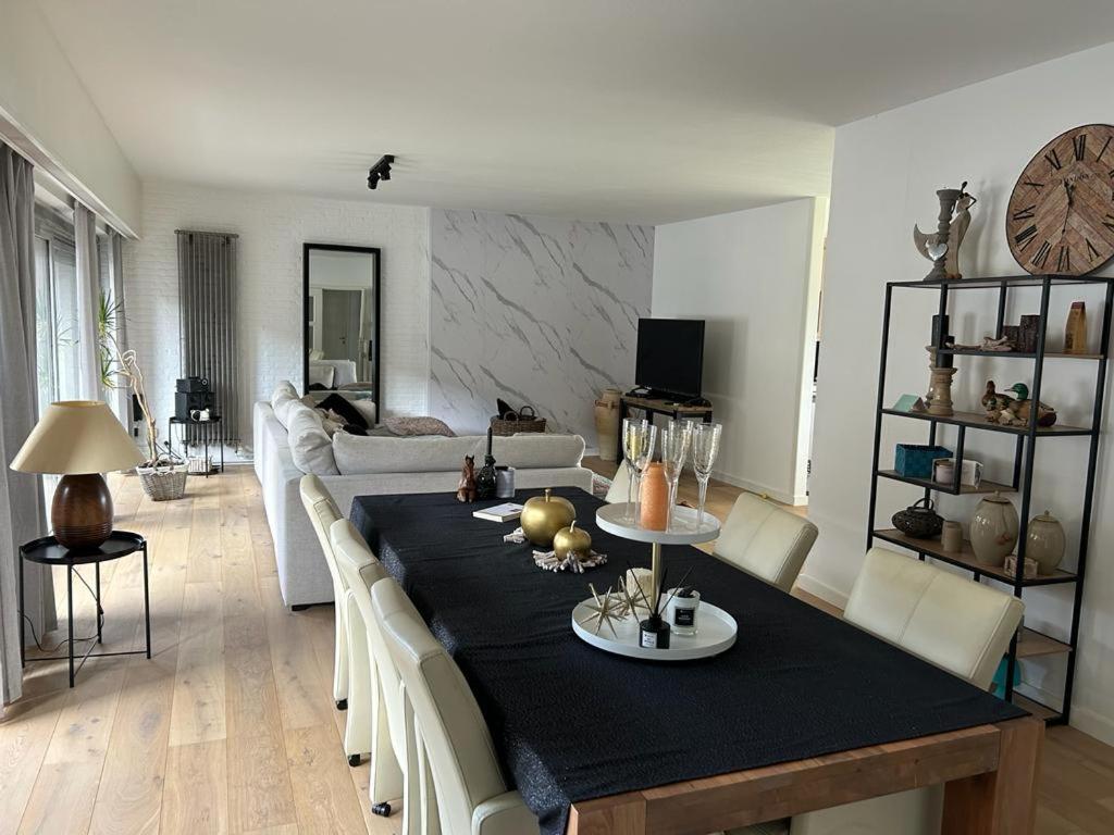sala de estar con mesa y sofá en Vakantie appartement Limburg, en Maaseik