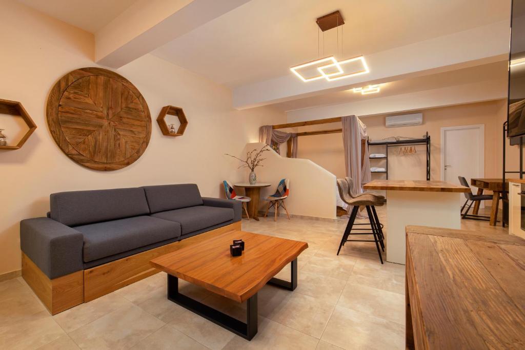 a living room with a couch and a table at Andros 4 All Seasons Villas & Suites in Andros