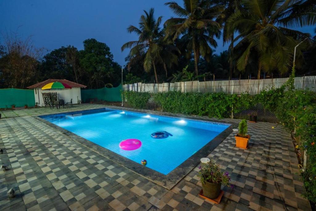 a swimming pool with two frisbees in it at SAI 4BHK VILLA ALIBAUG in Alibaug