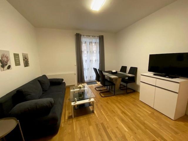 a living room with a couch and a table at Paky Appartements 00322 in Bruck an der Leitha