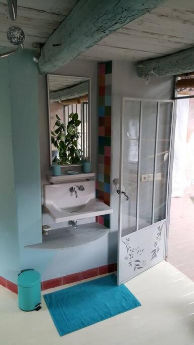 a bathroom with a sink and a mirror at Les papillons in Agnat