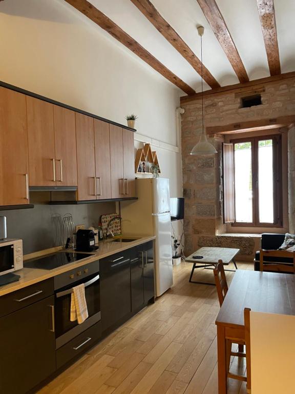 a kitchen with a refrigerator and a dining room at Espectacular Estudio en Antigua Casa de Correos in Molina de Aragón