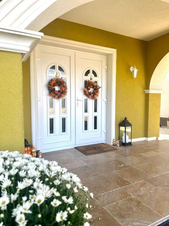 a front door of a house with wreaths on it at Alma Rezidence in Turda