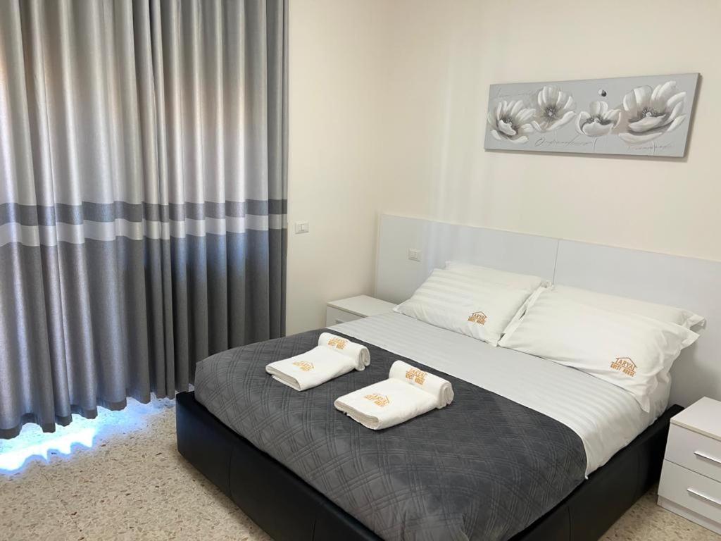 a bedroom with a bed with two towels on it at Guest House Arya in Rome