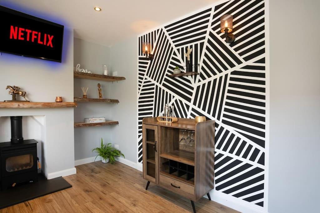 a room with a fireplace and a wall with black and white stripes at *Contractors, Holidays, Races, 25% off long stays* in Cheltenham