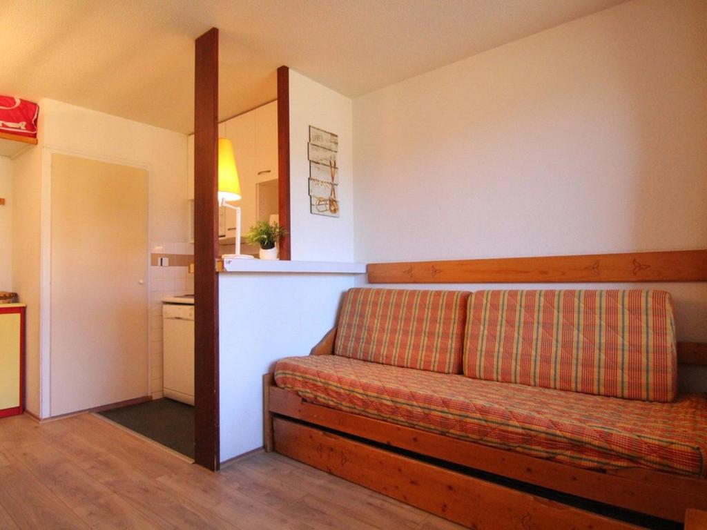 ein Wohnzimmer mit einem Sofa und einer Küche in der Unterkunft Appartement Huez, 2 pièces, 4 personnes - FR-1-405-155 in L'Alpe-d'Huez