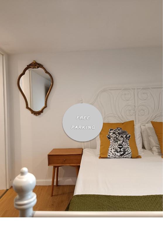 a bedroom with a bed and a mirror on the wall at M&R Apartments I in Koper