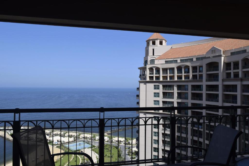 a view of a building and the ocean from a balcony at SAN STEFANO in Alexandria