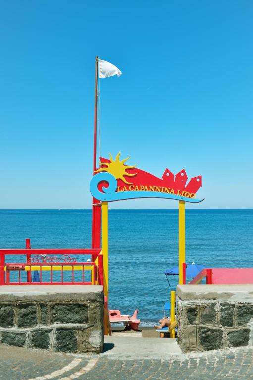 a colorful life guard station on the beach at La Capannina in Procida