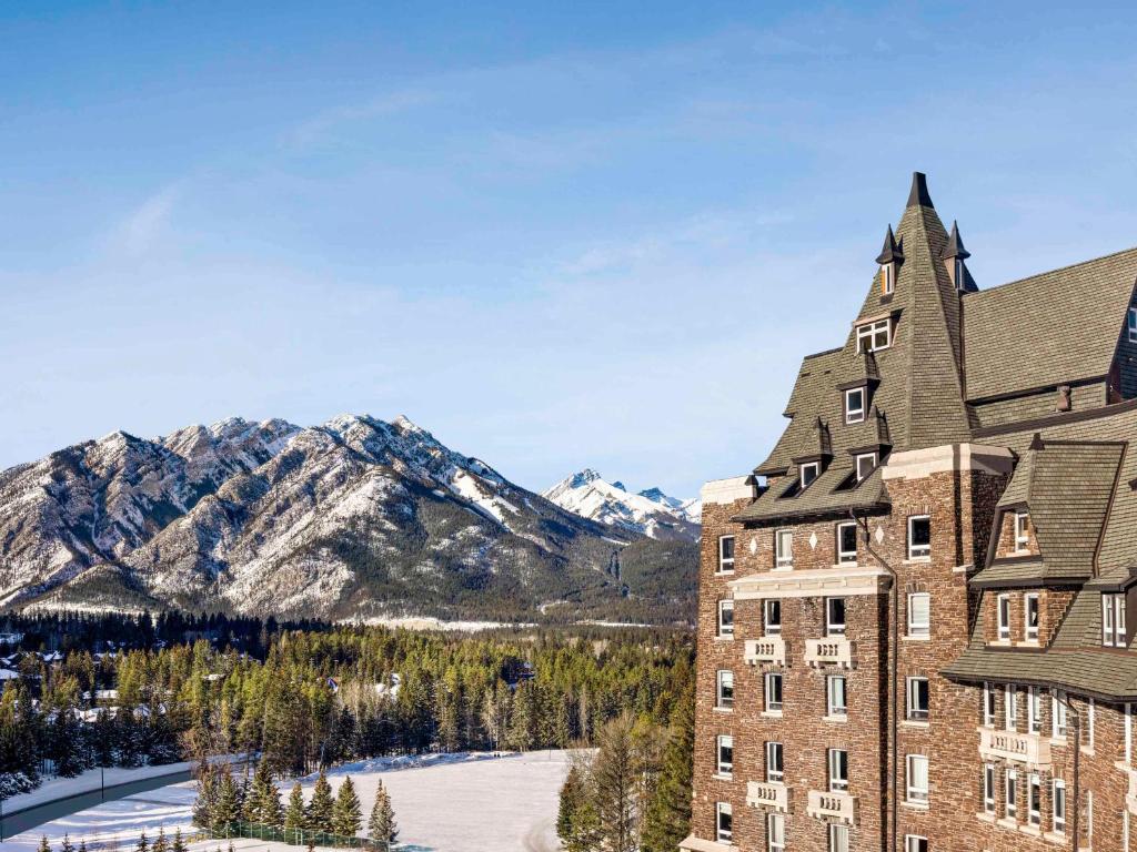a view of a hotel with mountains in the background at Fairmont Banff Springs in Banff