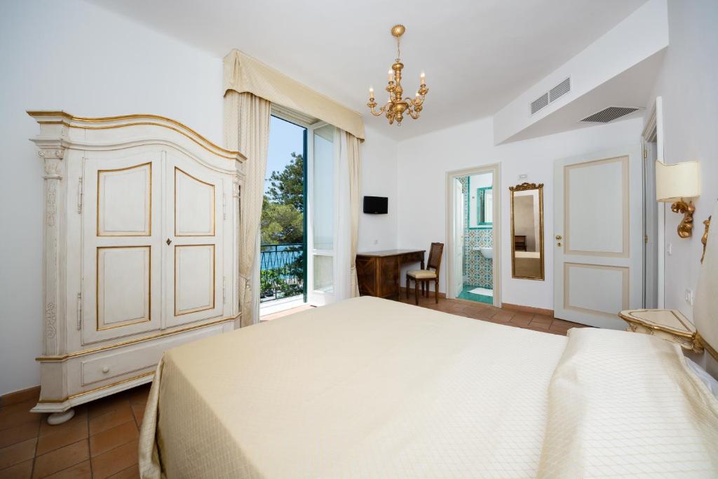 a bedroom with a large bed and a large window at Relais San Giacomo in Maiori