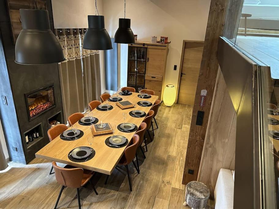 - une longue table en bois dans une chambre avec des chaises dans l'établissement La Montagne 2 ALPES 12 pers standing skis au pied, à Les Deux Alpes