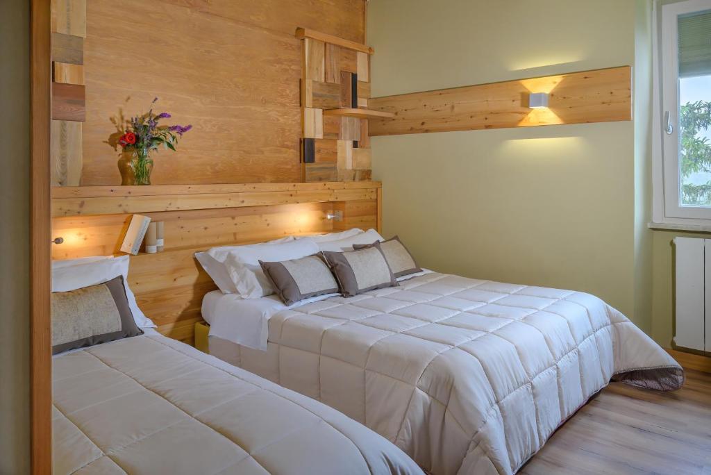 Postel nebo postele na pokoji v ubytování Ovindoli Park Hotel & SPA