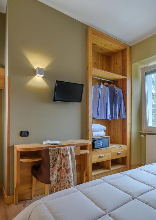 Postel nebo postele na pokoji v ubytování Ovindoli Park Hotel & SPA