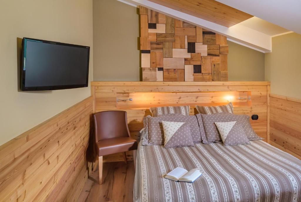 Postel nebo postele na pokoji v ubytování Ovindoli Park Hotel & SPA