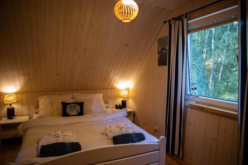 a bedroom with two white beds and a window at Morski Klimat Sasino in Sasino