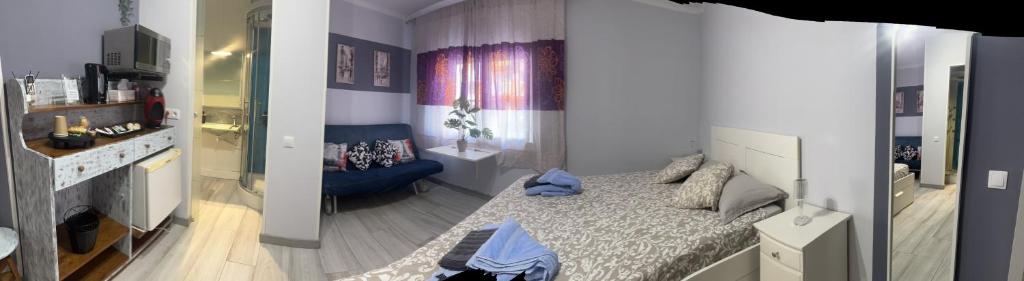 a small bedroom with a bed and a bathroom at stop & go in Arbós