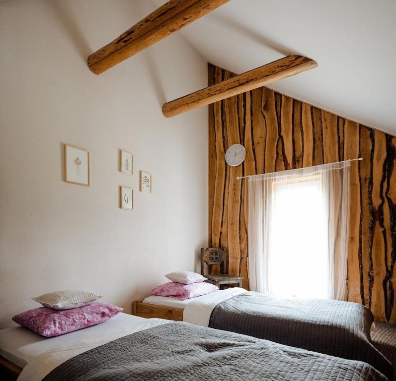 a bedroom with two beds and a window at ŽOLIŲ NAMELIS in Antalkiai