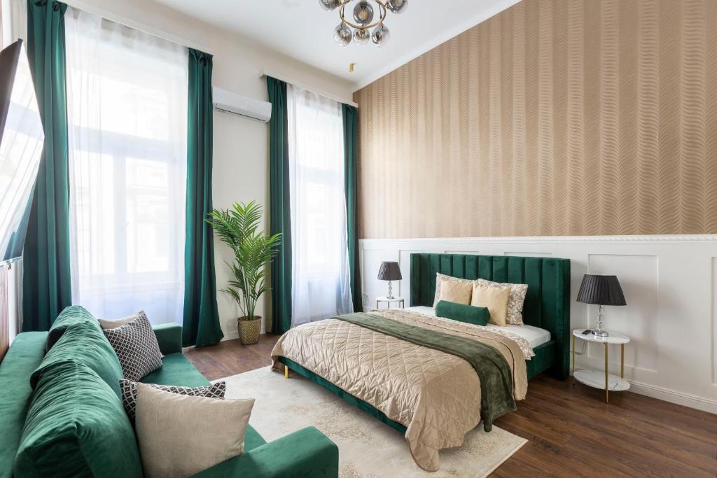 a bedroom with a bed and a couch at Luxurious Prestige Residence next to the New York Café in Budapest